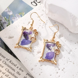 Golden rectangular frame earrings with natural purple dried flowers and gold foil accents