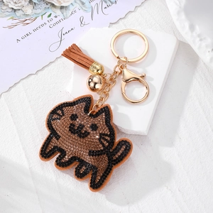 Porte-clés chat en strass avec pompon en cuir marron et petite clochette dorée