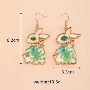 Detail showing 6.2cm long rabbit earrings with real dried flowers in gold resin frame