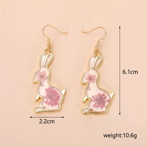 Detail shot of rabbit-shaped earrings showing pink dried flowers and 6.1cm size markings