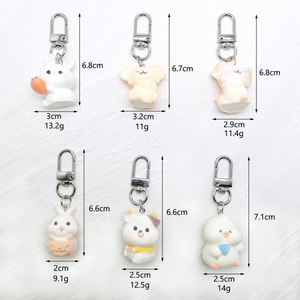 Detailed view of six cartoon animal flocking keychains with dimensions and silver clips