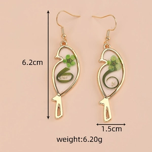 Detail showing dimension and weight of nature-inspired gold bird earrings with dried flowers