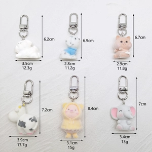 Detailed grid of six flocked animal keychains including puppies and hamsters with dimensions