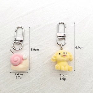 Detailed view of flocked animal keychains with silver lobster clasps and size measurements