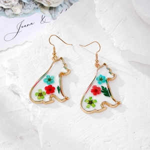 Detail view of handmade gold cat-shaped earrings featuring colorful real dried flowers in resin