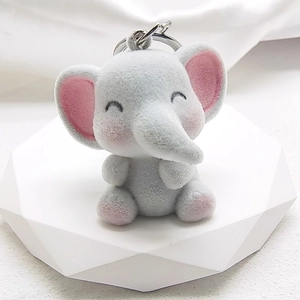 Detailed close-up of a grey flocked elephant keychain on a white display stand