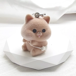 Detailed macro view of light brown flocked animal keychain with soft texture and metal ring