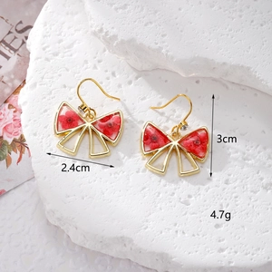 Elegant bow-shaped earrings with real red dried flowers in gold metal frames