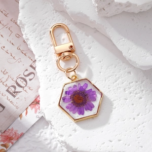 Handmade hexagonal resin keychain with real purple daisy flower and gold lobster clasp