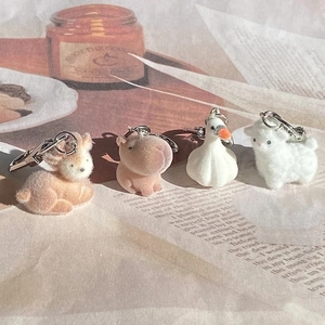 Cute flocked animal keychains featuring capybara, fox, and alpaca with metal clasps