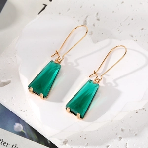 Minimalist gold-plated drop earrings featuring faceted emerald green trapezoid crystal