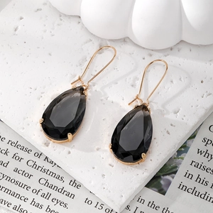 Detail of smoky grey teardrop crystal earrings with elegant faceted cut and gold settings