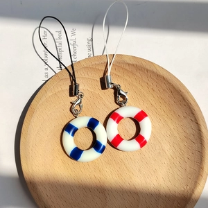 Cartoon summer lifebuoy pendant set with blue and red stripes on a wooden tray