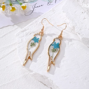 Bohemian bird-shaped resin earrings with blue and white dried flowers and gold hooks