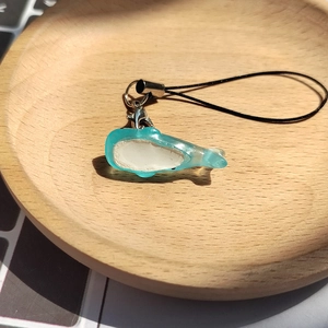 Cute light blue resin whale charm with silver lobster clasp and black lanyard strap