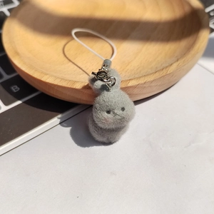 Detailed macro view of the grey flocked rabbit pendant texture with a white lanyard strap
