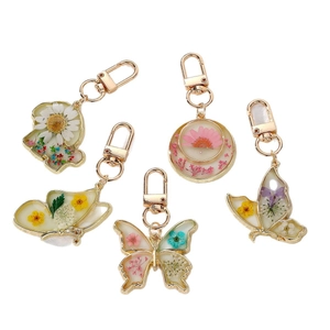Luminous butterfly and daisy dried flower resin keychain set with golden alloy clasp