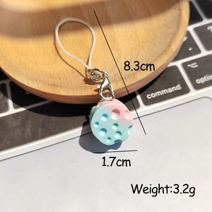 Detailed view of pink-blue gradient resin charm with lobster clasp and white phone strap