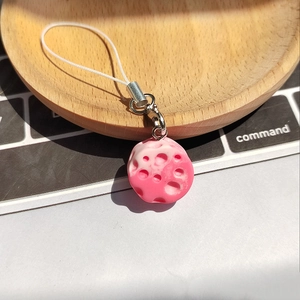 Macro detail of a pink lunar meteorite resin charm with realistic crater texture and silver ring