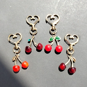 Chic resin cherry heart keychain pendants in various red shades for stylish bag decoration