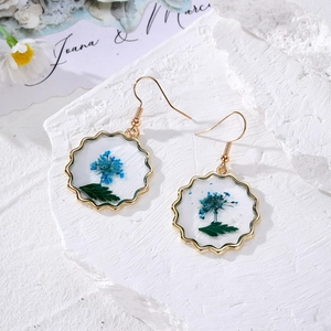 Vintage gold drop earrings with real blue dried flowers in a clear round resin frame