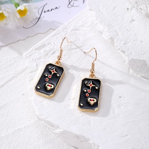 Detail view of tarot style earrings with gold star motifs and black enamel on stone