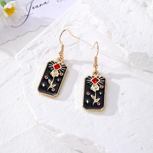 Star Moon Tarot earrings in gold metal with black enamel rose pattern and hook design