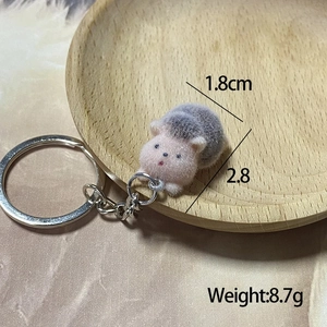 Detailed view of pink flocking hedgehog keychain with dimensions of 1.8cm by 2.8cm