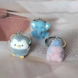 Detail of cute flocked animal keychains featuring penguin, elephant, and hippo designs