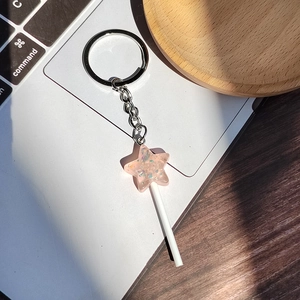 Pink resin star lollipop keychain with glitter flakes and silver metal ring for bags