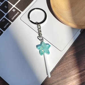 Sparkly mint green resin star lollipop keychain with silver metal ring and chain