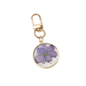 Bohemian gold keychain with a purple dried flower and gold foil in a clear resin pendant