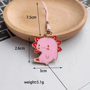 Detailed view of a cute pink axolotl enamel charm on a laptop with dimension markings