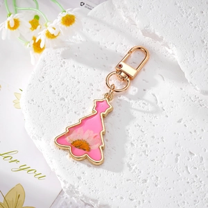 Porte-clés sapin de Noël doré avec fleur de marguerite séchée rose et fermoir