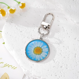Porte-clés marguerite rond chic avec fond bleu et fermoir mousqueton en métal argenté