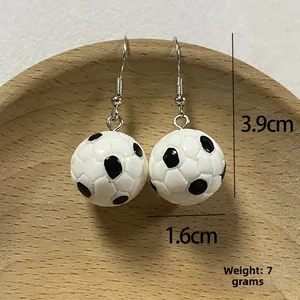 Detailed view of 3D soccer ball resin earrings with silver hooks and 1.6cm diameter ball