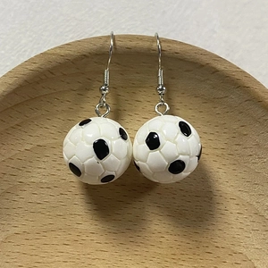 3D mini resin football earrings with black and white soccer ball design and silver ear hooks