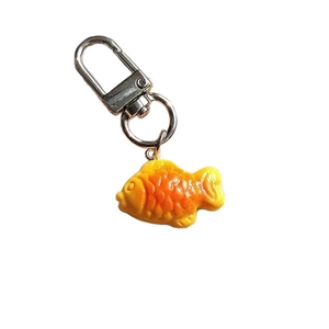 Realistic orange resin Taiyaki fish keychain with detailed scales and silver carabiner