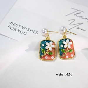 Detail of French vintage floral enamel earrings with pearls in green and pink