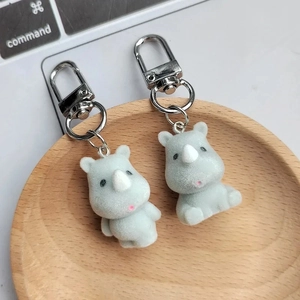 Cute rhino plush keychains featuring light blue flocked texture and silver metal clasp