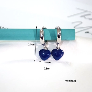 Detailed view of dark blue enamel heart drop earrings measuring 2.1cm high and 0.8cm wide