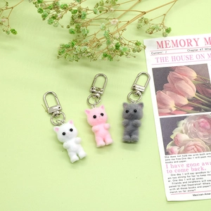 Three cute flocked kitten keychains in white, pink, and grey with silver lobster clasps