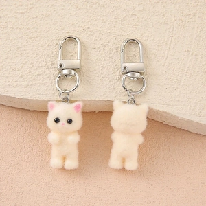 Front and back view of cute beige flocked cat keychains with pink ears and silver clips