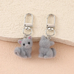 Detail view of two cute flocked grey cat charms with durable silver metal lobster clasps