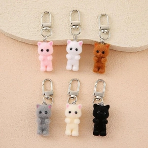 Detailed view of six colorful flocked cat keychains with fluffy texture and metal clasps