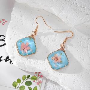 Handmade resin earrings with pink dried flowers and gold wire wrapped stainless steel hooks