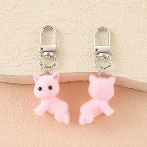 Detailed close-up showing front and back of pink flocked cat plush keychain with silver clip
