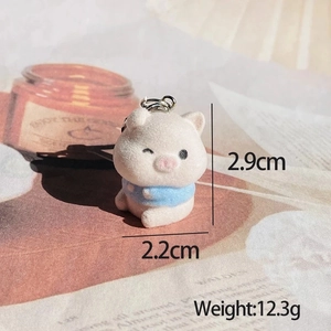 Detail of cute flocked pig keychain wearing a blue sweater, 2.9cm mini animal charm