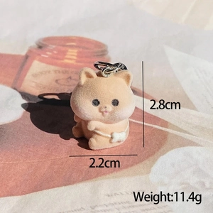 Macro shot of a flocked animal keychain with a white bow, size 2.8cm and 11.4g weight