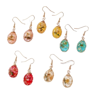 Five pairs of handmade copper wire-wrapped resin earrings with dried flowers and pearls